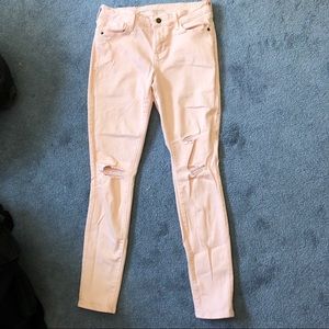 Light pink lightly worn torn jeans
